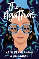 The cover for The Agathas. A teen girl with pale skin and brown hair raises an eyebrow at a figure reflected in her sunglasses. That teen has blonde hair and also wears sunglasses. Our main teen peers out between leaves. 